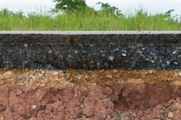 istock The layer of asphalt road with soil and rock. 867679212