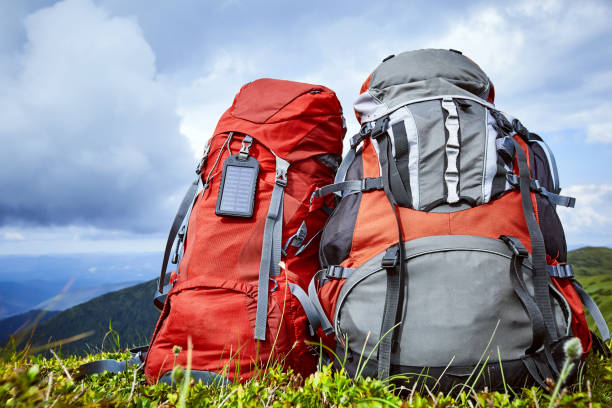 istock Backpacks in the mountains overlooking the mountains on the green grass. 867682892