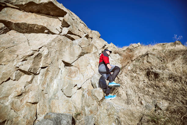 istock The guy is running on a difficult terrain in the mountains. 867685168