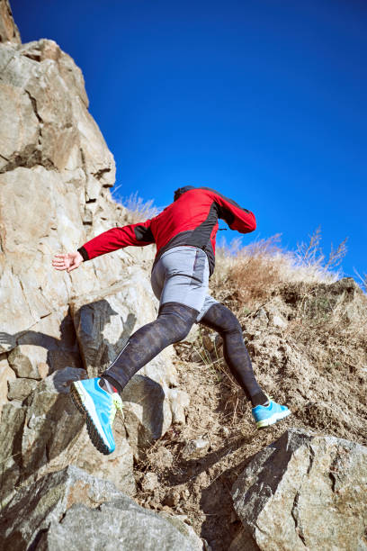 istock The guy is running on a difficult terrain in the mountains. 867685170