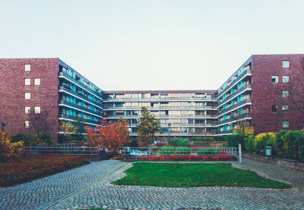 istock apartment complex with a green park in the inside 867685228