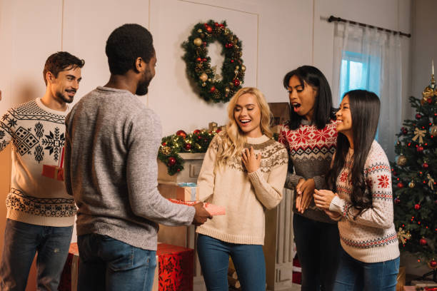 istock multicultural friends exchanging christmas gifts 867685310