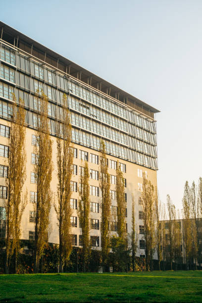 istock office building with glass roof and park in the front side 867685798