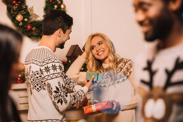 istock multiethnic couple exchanging christmas gifts 867688872