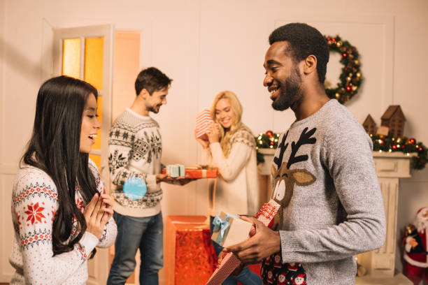 istock multiethnic couples exchanging christmas gifts 867689332