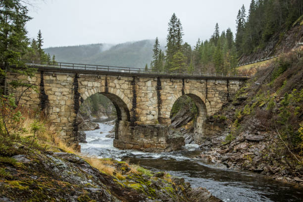 istock A beautiful historic stone bridge crossing the river in central Norway. 867692758