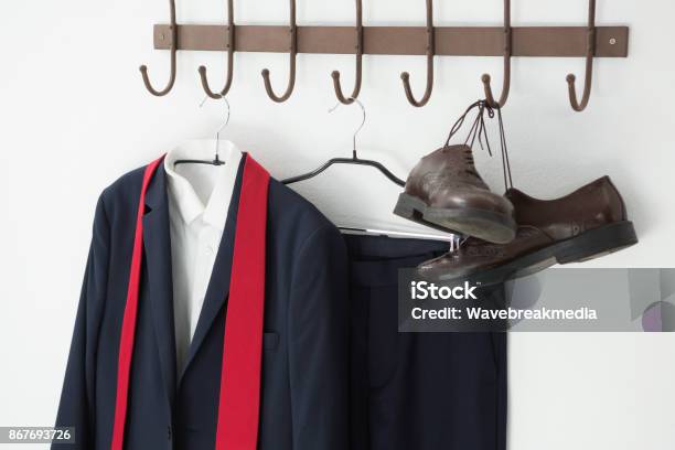 Closeup Of Full Suit And Shoes Hanging On Hook Stock Photo - Download Image Now - Absence, Blazer - Jacket, Button Down Shirt