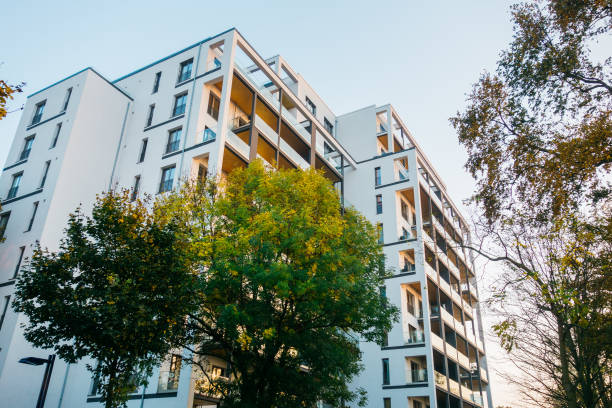 istock big apartment complex with green trees and warm colored balcony 867695870
