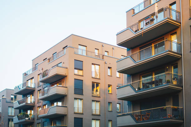istock grey facaded big apartment complexes in a row 867696650