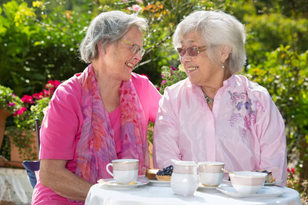 istock Two senior women chatting at table. 867696762