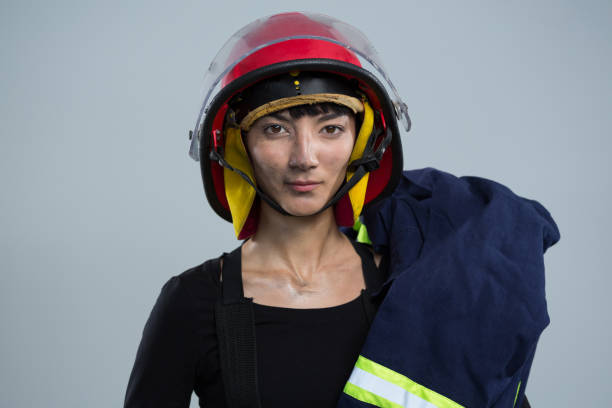 istock Female architect wearing helmet against white background 867700446