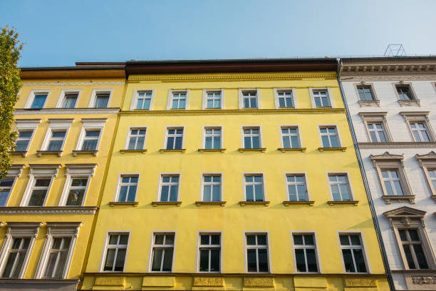 istock yellow facade of apartment building in low angle view 867703608