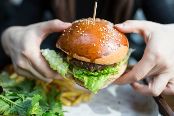 istock Woman eating some burger 867704018