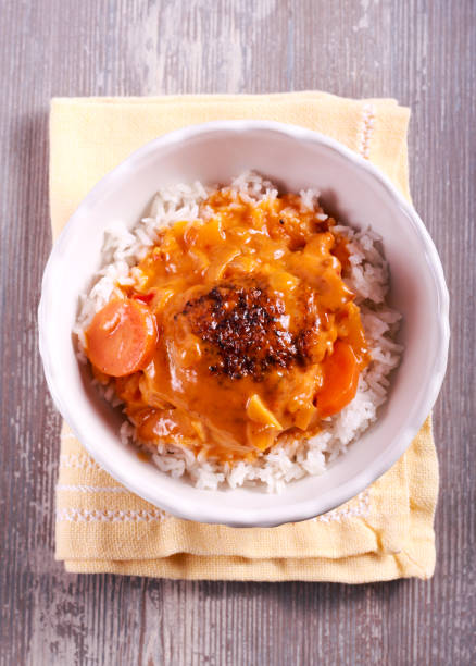 istock Chicken thigh with gravy over rice 867704030