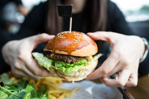 istock Woman eating some burger 867704662