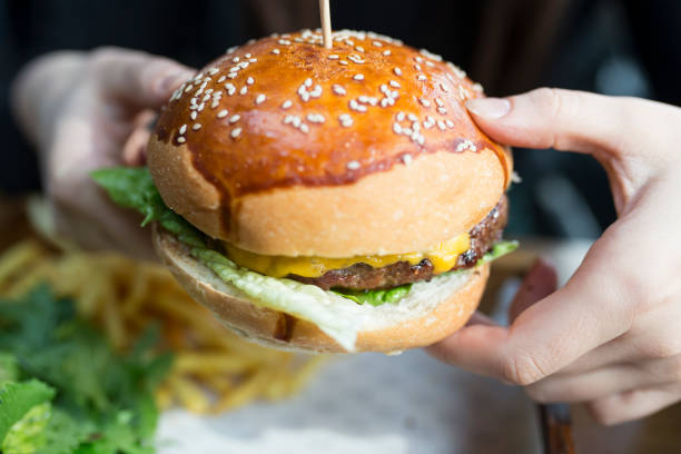 istock Woman eating some burger 867705080