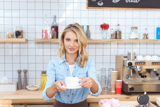 istock barista holding cup of coffee 867722920