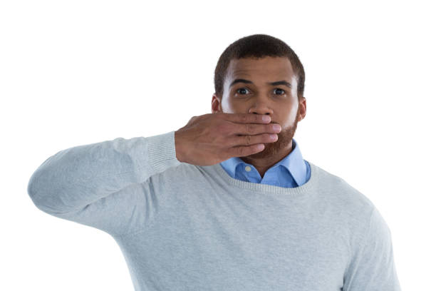 istock Male executive covering his mouth with hand 867723266