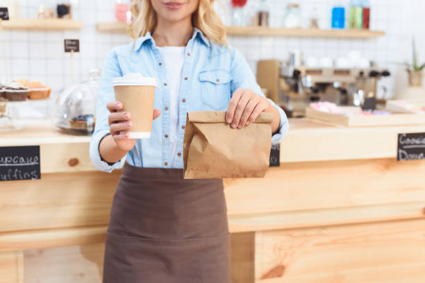 istock waitress holding coffee to go 867723558