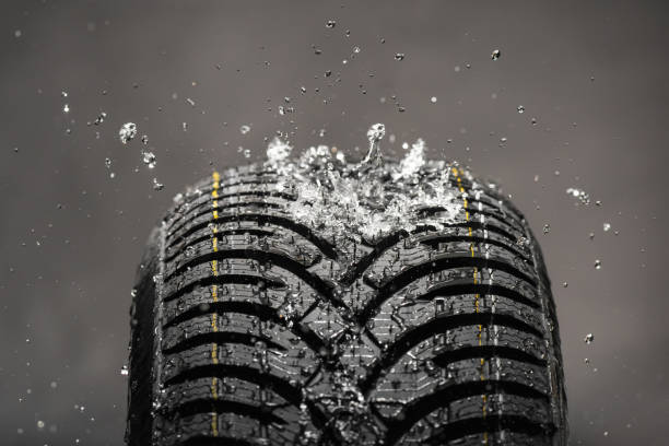 istock Water splashing on new winter tire during the rain 867724052