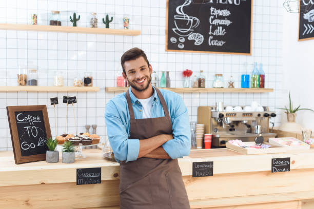 istock barista in apron standing with crossed arms 867726944