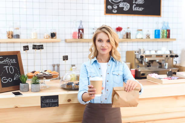 istock waitress holding coffee to go 867728448