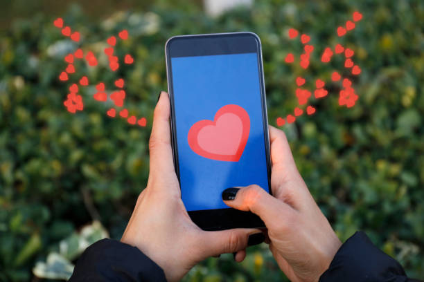 istock Hand holding smart phone with sending heart 867729702