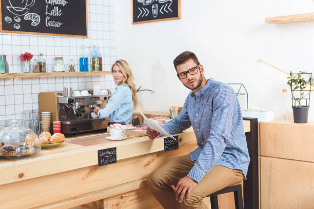 istock man reading newspaper in cafe 867729788