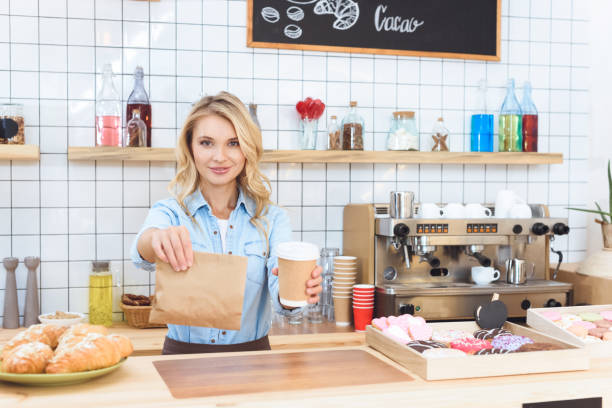 istock waitress holding coffee to go 867732894