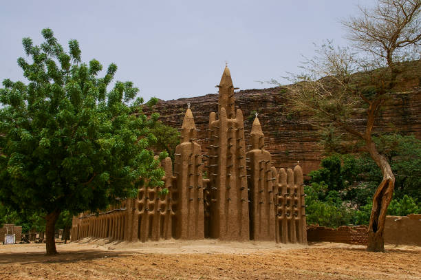 Mud Mosque and Cliff of Bandiagara in Kani-Kombole village, Dogon Country, Bandiagara, Mali - July, 2009 stock photo