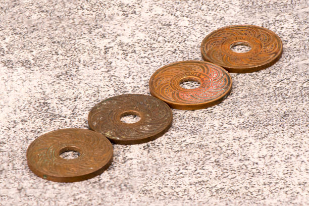 istock Old Ancient Coins Of Thailand isolated on concrete background 867736394