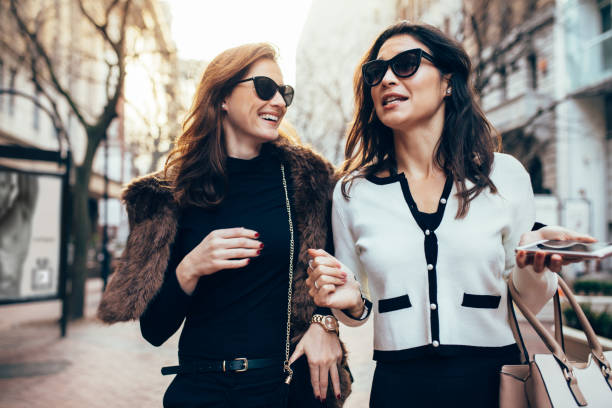 istock Female friends walking on the road 867736604