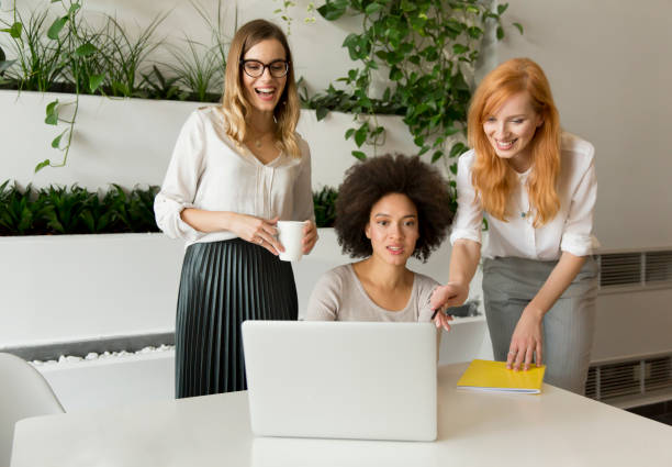 istock Three young businesswomen in the office 867742526