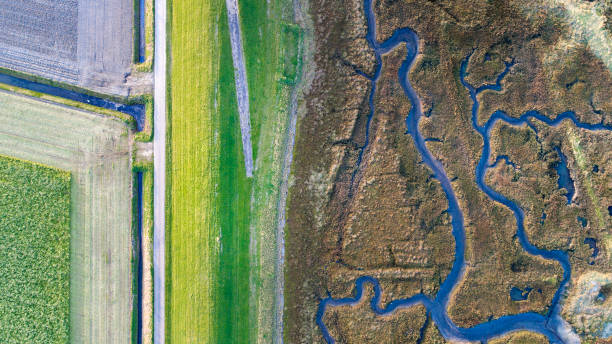 istock Dyke, salt marsh and coastline - aerial view 867742630