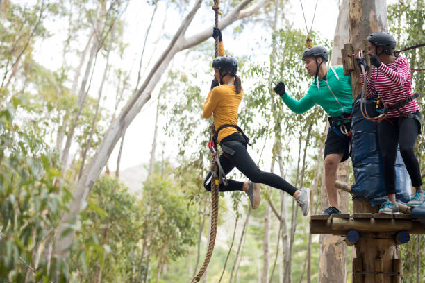 istock Woman enjoying zip line adventure in park 867742948