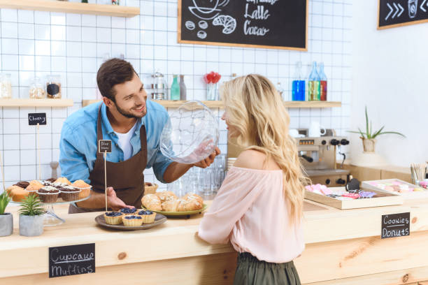istock waiter showing cookies to client 867745876