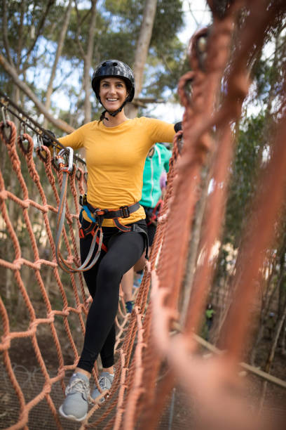 istock Woman walking on rope bridge 867747026