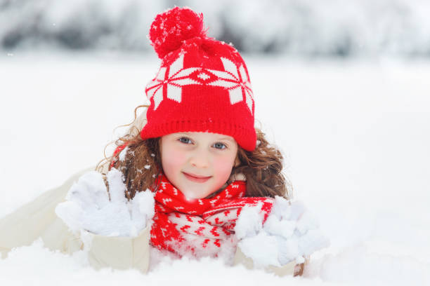 istock Little girl lying on snow. 867747340