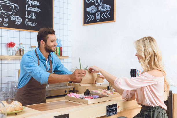 istock waiter giving take away food to client 867747402