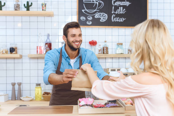 istock waiter giving take away food to client 867747536