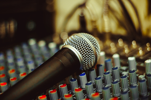 the microphone rests on an audio mixer