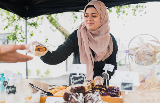 istock Muslim woman serving customer. 867751030
