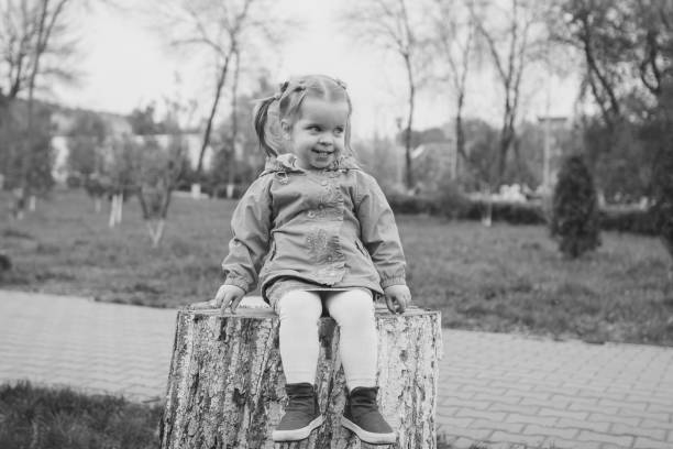 girl sitting on a stump - ticket ticket stub park fun imagens e fotografias de stock