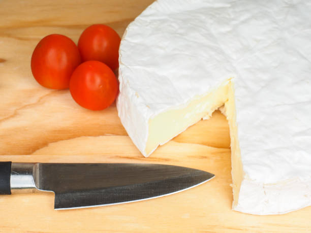 istock Traditional soft white cheese with tomato and knife 867754414