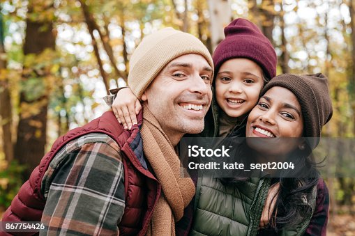 istock Family close up portrait in warm clothes at the park 867754426