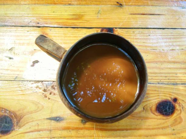 istock Hot coffee in coconut shell cup on a wooden table- top view 867756720