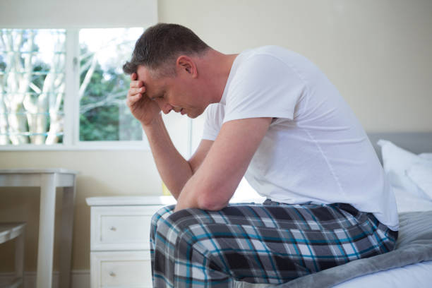 istock Worried man having a headache in bedroom 867761100
