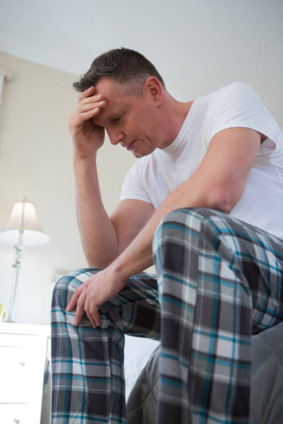 istock Worried man having a headache in bedroom 867761108