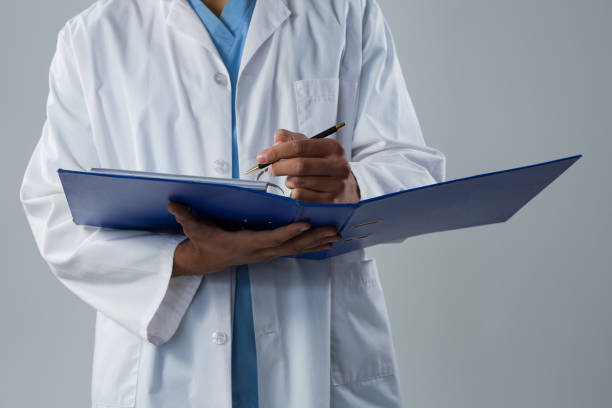 istock Doctor writing a reports in the file 867764474