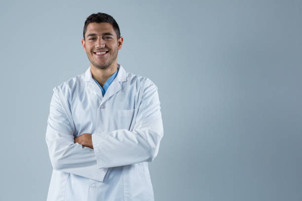 istock Smiling doctor standing with his hands crossed 867764554